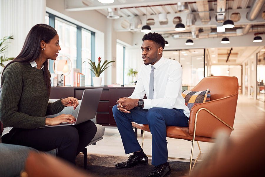 Business Insurance - Businesswoman Interviewing a Job Candidate for a Job Opening in the Seating Area of a Modern Office