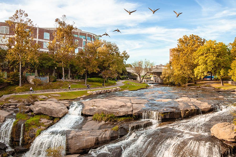 Contact - Picturesque View of River City in Greenville, South Carolina with Birds at Dusk