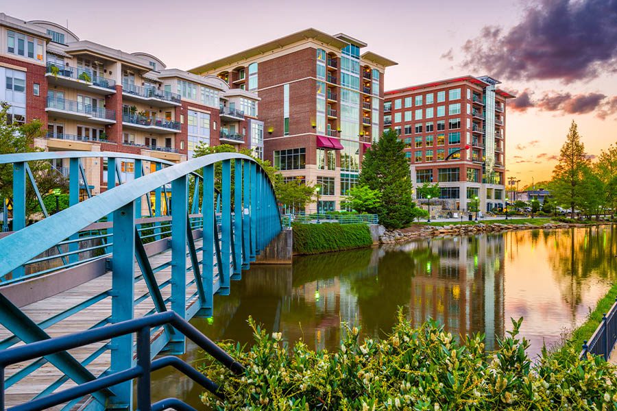 Greenville, SC - Downtown View of Greenville, South Carolina Cityscape on the Reedy River at Dusk